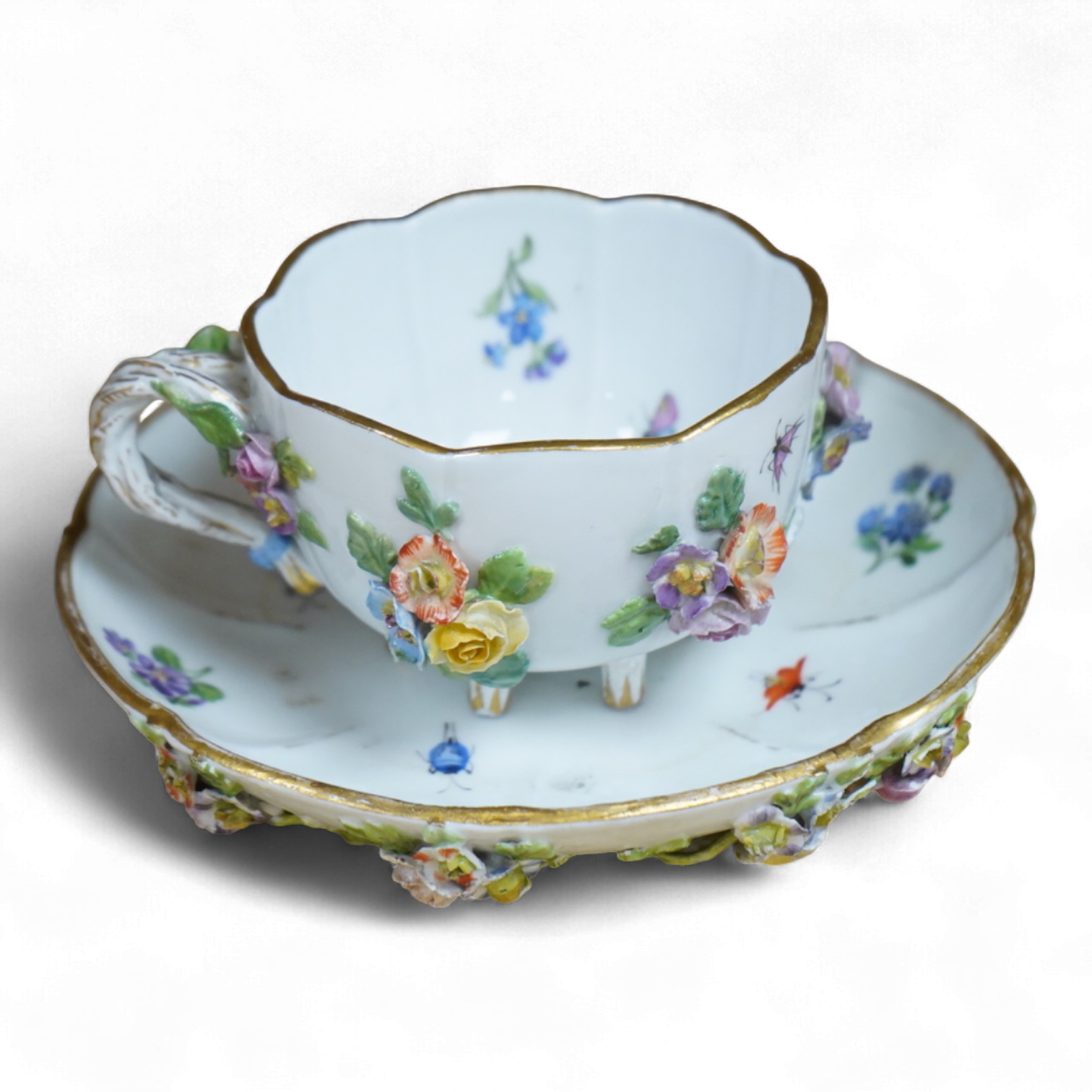 A 19th century Meissen floral encrusted cup and saucer, 14cm diameter